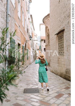 Happy woman walking in shopping street in Italy on vacation dressed in summer fashion dress. 139038637