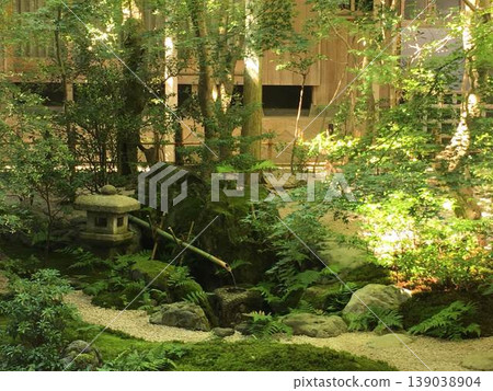 A beautiful garden scene of wabi-sabi, with moss-covered rocks and a water basin, stone lanterns and sunlight filtering through the trees. A beautiful garden scene of wabi-sabi, with moss-covered rocks and a water basin, stone lanterns and sunlight filtering through the trees. 139038904