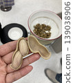 一張新鮮去殼煮熟的大花生特寫照片，以及一張新鮮當季花生被拿在手中的照片，花生既可作為零食，也是當地美食的食材。 139038906