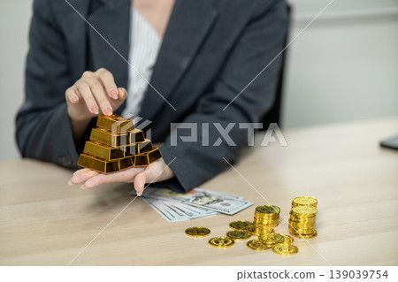 Asian adult hands holding gold bars displaying finance investment business wealth management security growth for future prosperity Asian adult hands holding gold bars displaying finance investment business wealth management security growth for future prosperity 139039754