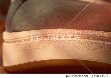 Warm morning footwear highlight. Photographic capture of bright sneaker heel emphasizing craftsmanship and cozy ambiance 139039864