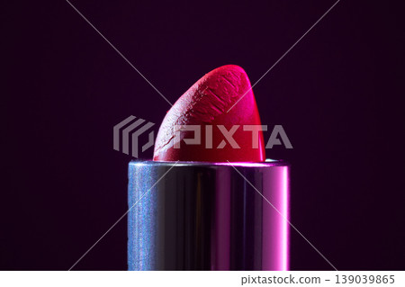 Lipstick closeup. Close inspection of vibrant red lipstick surface. Product portrayal highlighting texture and glossy finish under studio lighting Lipstick closeup. Close inspection of vibrant red lipstick surface. Product portrayal highlighting texture and glossy finish under studio lighting 139039865