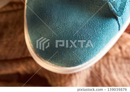 Sneaker sole stitching closeup showing welt and rubber midsole, textured suede upper and seam detail Sneaker sole stitching closeup showing welt and rubber midsole, textured suede upper and seam detail 139039876