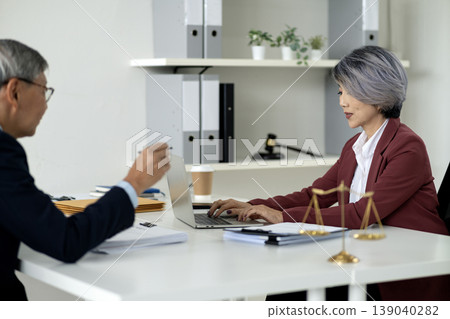 Asian adult legal professionals discuss important cases collaborate laptop modern law office consultation justice scales for business expertise Asian adult legal professionals discuss important cases collaborate laptop modern law office consultation justice scales for business expertise 139040282