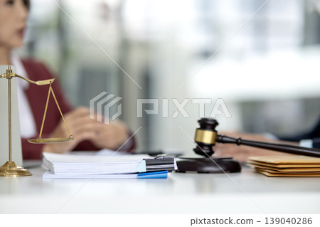 Lawyer consultant provides legal advice adult clients discuss documents scales of justice gavel symbol law office business meeting attorney 139040286