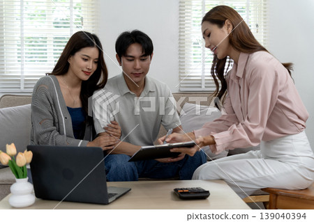 Asian adult couple consulting financial advisor about investment home loan real estate planning secure family future modern living room 139040394
