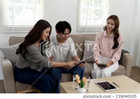 Asian adult couple meeting financial advisor consultant home living room discussing financial plan investment future property purchasing mortgage insurance budgeting real estate family wealth Asian adult couple meeting financial advisor consultant home living room discussing financial plan investment future property purchasing mortgage insurance budgeting real estate family wealth 139040395