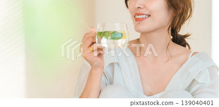 Women who drink detox water, lemon water, and mint water. Women who drink detox water, lemon water, and mint water. 139040401