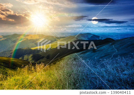 day meet night. mountain landscape with alpine meadow. sun and moon over carpathian mountain scenery on summer solstice. view in to the distant valley landscape. rolling hills and grassy meadow day meet night. mountain landscape with alpine meadow. sun and moon over carpathian mountain scenery on summer solstice. view in to the distant valley landscape. rolling hills and grassy meadow 139040411