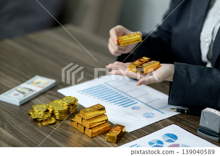 Asian adult professional hands hold gold bars presenting wealth management investment strategy financial planning business growth asset diversification Asian adult professional hands hold gold bars presenting wealth management investment strategy financial planning business growth asset diversification 139040589