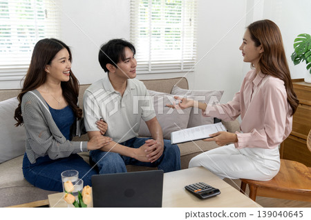 Asian young adults consult financial advisor at home discussing investment retirement plans property purchase loan documents 139040645