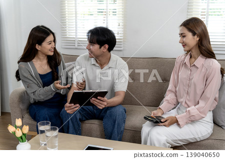Asian adults discuss finance planning wealth management investment strategies home office Asian adults discuss finance planning wealth management investment strategies home office 139040650