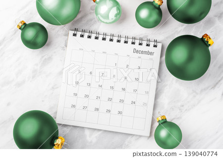Holiday planning, december calendar with green christmas ball ornaments on white marble background 139040774