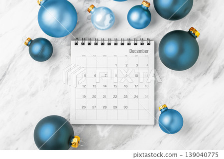 Holiday planning, december calendar with blue christmas ball ornaments on white marble background 139040775