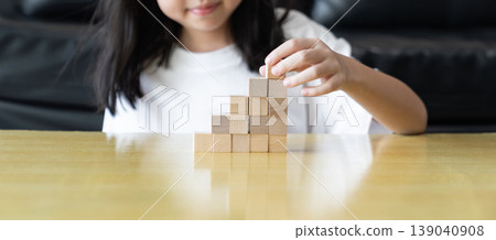 Wooden blocks rising steps child behind patience effort planning strategy step progress focus control consistency logical development achievement. 139040908