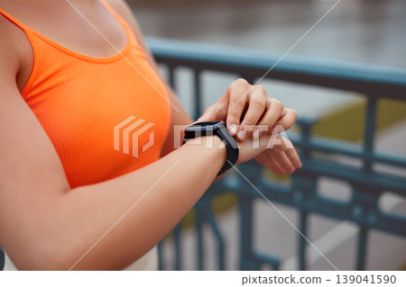 Woman Checking Smart Watch Before Running and Using Wireless Earbud. Fitness. 139041590