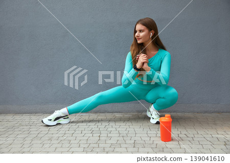 Beautiful fit woman stretching. Woman working out on steps outdoors. Beautiful fit woman stretching. Woman working out on steps outdoors. 139041610