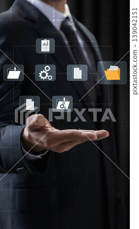 A professional businessman holds his hand out with floating digital icons symbolizing document management, data processing, file storage, and business information systems A professional businessman holds his hand out with floating digital icons symbolizing document management, data processing, file storage, and business information systems 139042151