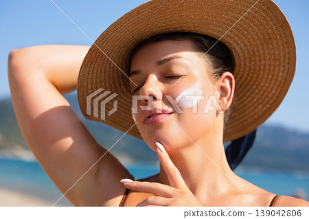 Attractive Woman Relaxing With Closed Eyes In Sunlight At Beach. Beauty Skincare Concept. Female Enjoying Summer Sun And Healthy Skin Attractive Woman Relaxing With Closed Eyes In Sunlight At Beach. Beauty Skincare Concept. Female Enjoying Summer Sun And Healthy Skin 139042806