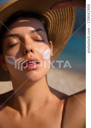 Beauty Woman With Closed Eyes And Sunscreen On Face At Beach. Skincare And Sun Protection Concept. Female Relaxing In Sunlight Beauty Woman With Closed Eyes And Sunscreen On Face At Beach. Skincare And Sun Protection Concept. Female Relaxing In Sunlight 139042808