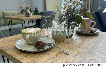 cup of coffee and cake on the table in cafe 139043078