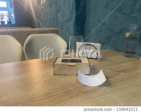a table in cafe with check box and a glass of water 139043211