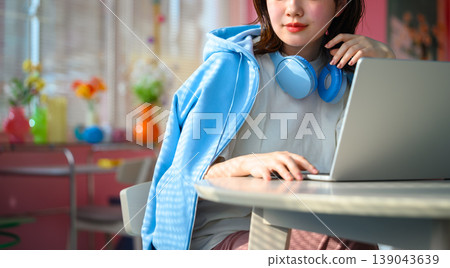 Woman working on a laptop: Happy Pop Woman working on a laptop: Happy Pop 139043639