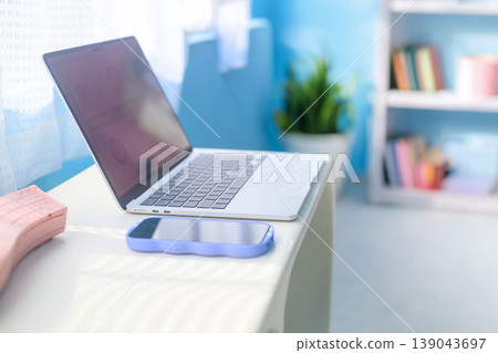 桌上放著一台筆記型電腦和一部智慧型手機：快樂流行樂 139043697
