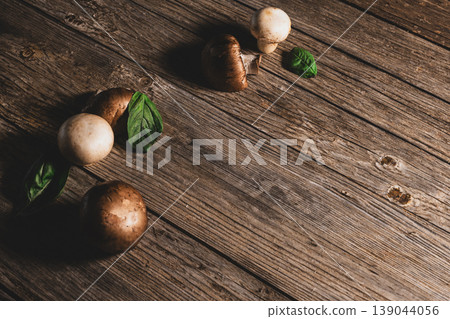 Top View of Mushrooms and Fresh Mint Leaves on Wood. Mushrooms and Mint Leaves on Wooden Surface. Top View of Mushrooms and Fresh Mint Leaves on Wood. Mushrooms and Mint Leaves on Wooden Surface. 139044056