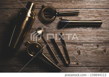 Luxury Golden Barware Set for Mixology on Wood Background. 139044113