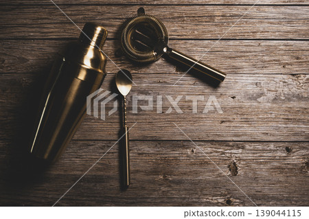 Luxury Golden Barware Set for Mixology on Wood Background. Luxury Golden Barware Set for Mixology on Wood Background. 139044115
