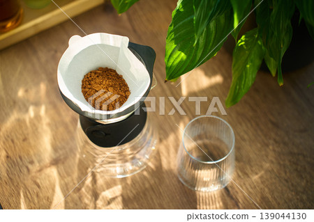 Ground coffee in paper filter for pour over brewing Ground coffee in paper filter for pour over brewing 139044130