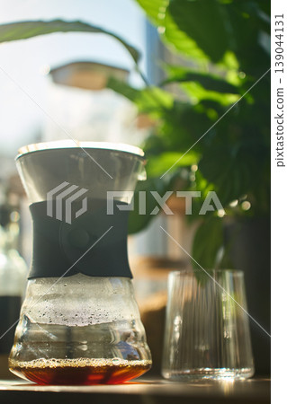 Brewed filter coffee in pour over carafe by window 139044131