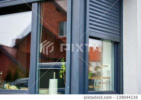 Residential window with partially closed roller shutter Residential window with partially closed roller shutter 139044138