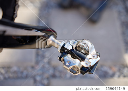 Close up of clipless bicycle pedal on bike crank arm 139044149