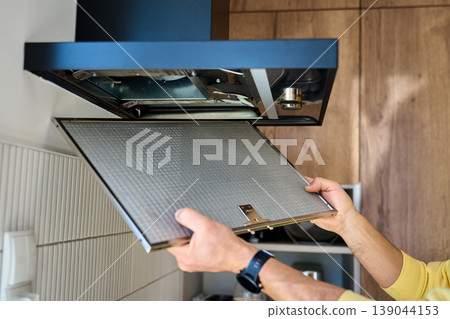 Removing metal filter from kitchen hood for cleaning 139044153