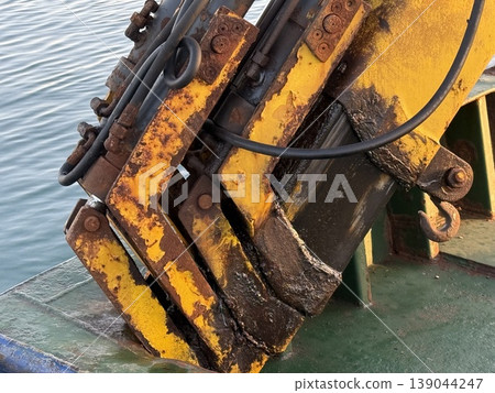 Industrial machinery detail with rust on yellow metal in closeup, suitable as textured background Industrial machinery detail with rust on yellow metal in closeup, suitable as textured background 139044247
