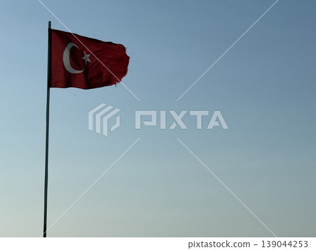 Turkish flag against clear blue sky background with space for text Turkish flag against clear blue sky background with space for text 139044253