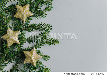 Beautiful Christmas ornaments and spruce branches on a grey background. Beautiful Christmas ornaments and spruce branches on a grey background. 139044297