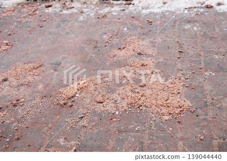 A hill of anti-ice mixture lies on the road 139044440