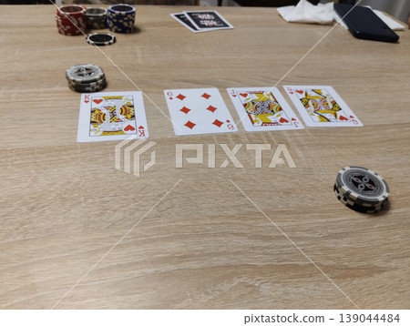 Mozyr, Belarus, April 10 2024: Playing Poker with Cards and Chips on the Table Mozyr, Belarus, April 10 2024: Playing Poker with Cards and Chips on the Table 139044484