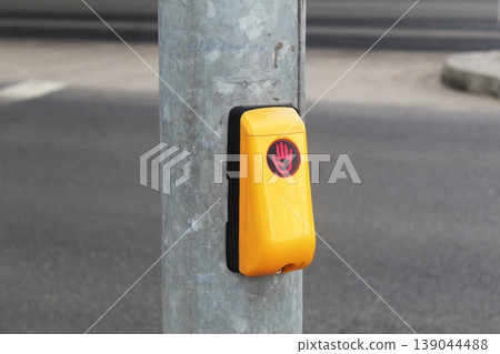Green traffic light call button at a pedestrian crossing Green traffic light call button at a pedestrian crossing 139044488