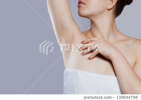 Armpit epilation, lacer hair removal. Young woman holding her arms up and showing clean underarms, epilation on smooth clear skin .Beauty portrait. Skin care. Armpit epilation, lacer hair removal. Young woman holding her arms up and showing clean underarms, epilation on smooth clear skin .Beauty portrait. Skin care. 139044798