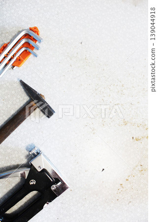 Concept background on the theme of construction and renovation. Hammer screwdriver construction stapler with space for text copyspace 139044918