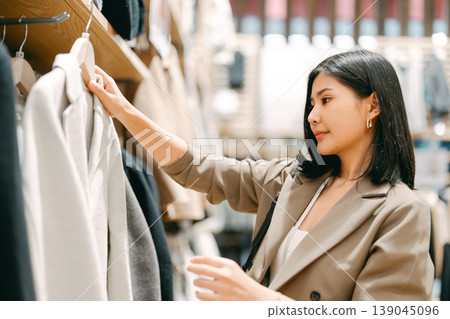 Business woman shopping clothing shop in department store after work life baclance modern lifestyles Business woman shopping clothing shop in department store after work life baclance modern lifestyles 139045096