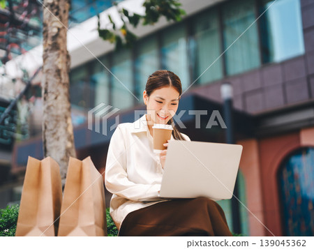 Freelancer smiling face asian business woman using laptop digital nomad work and travel lifestyles Freelancer smiling face asian business woman using laptop digital nomad work and travel lifestyles 139045362