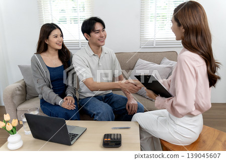 Asian adult couple professional meeting home consultation handshake agreement future planning property financial service investment discussion Asian adult couple professional meeting home consultation handshake agreement future planning property financial service investment discussion 139045607