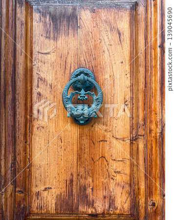 vintage bronze door knocker on old wooden door panel vintage bronze door knocker on old wooden door panel 139045690