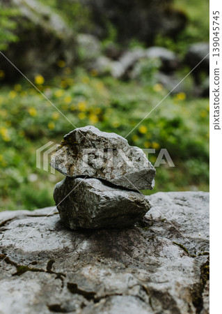 Two stones one in on top of the other on a natural background. Two stones one in on top of the other on a natural background. 139045745