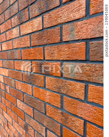 Brick wall made of red and brown bricks in a structured pattern during daytime in an urban area Brick wall made of red and brown bricks in a structured pattern during daytime in an urban area 139045869